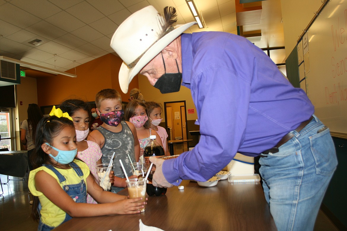 Rep. Tom Dent, R-Moses Lake, adds the root beer part of a root beer float at the  Boys & Girls Clubs of The Columbia Basin Thursday.