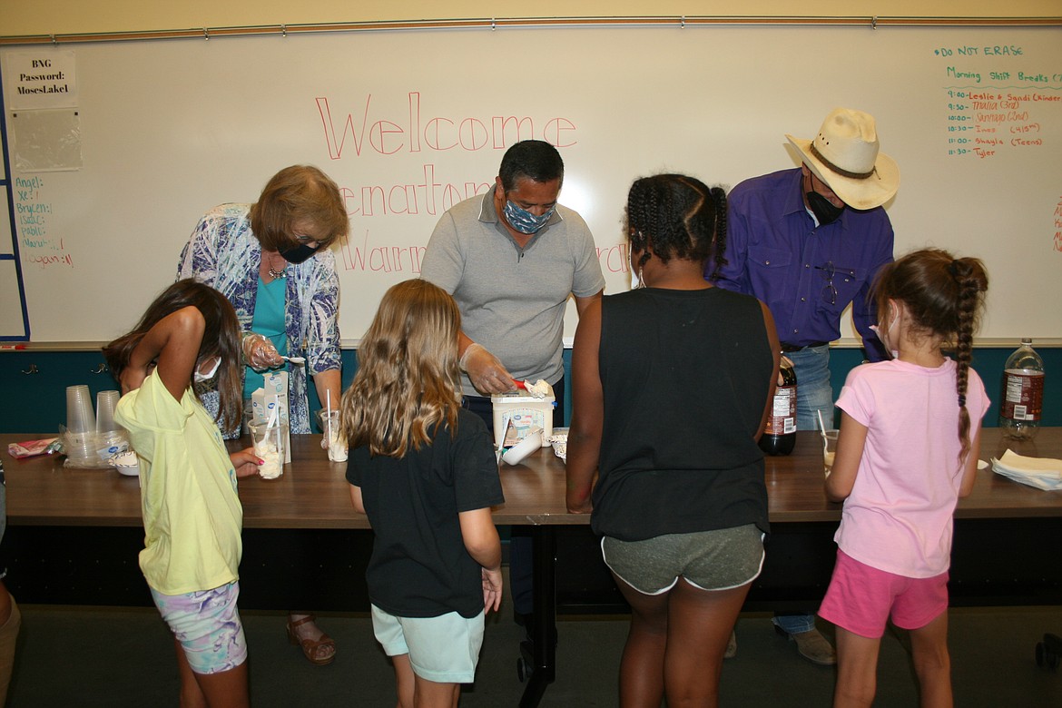 From the left, state Sen. Judy Warnick, R-Moses Lake, Rep. Alex Ybarra, R-Quincy, and Rep. Tom Dent, R-Moses Lake, dish up ice cream and root beer for kids at the Boys & Girls Clubs of The Columbia Basin Thursday.