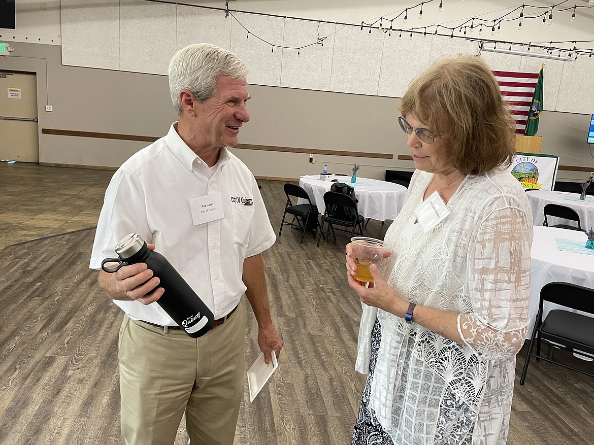 Quincy City Administrator Pat Haley shows off a customized metal water bottle to Sen. Judy Warnick, R-Moses Lake, during the June 30 ceremony to formally make the opening of the Quincy Water Reuse Utility.