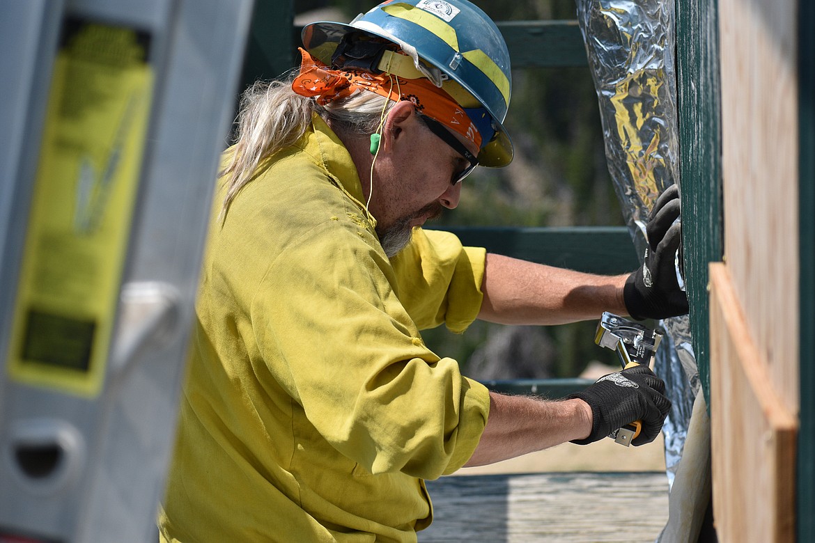 Charley Rosier wraps the lookout tower on Saturday.