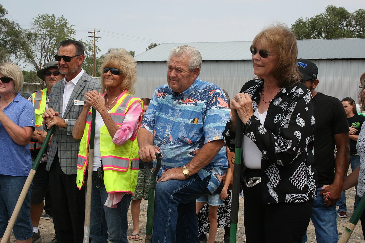 From the left: Moses Lake Mayor David Curnel, Moses Lake Food Bank Director Peny Archer, Mick Hansen and Sen. Judy Warnick, R-Moses Lake, listen to a speech during groundbreaking ceremonies for the new food bank Monday.