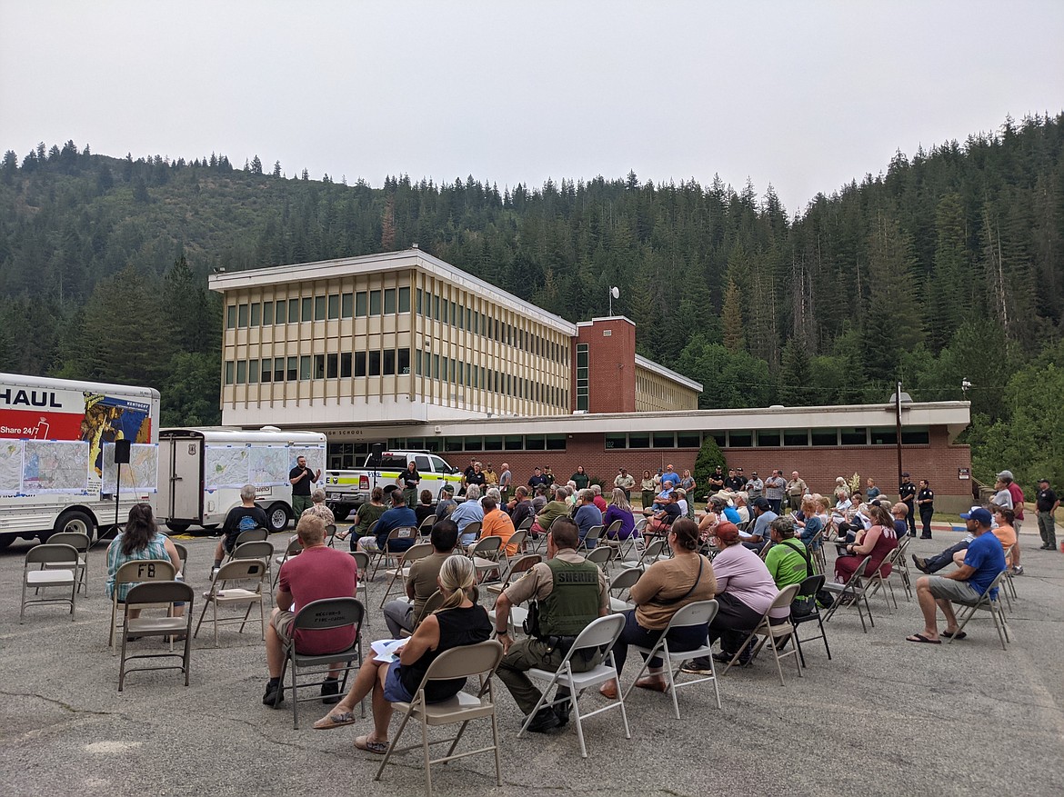 Concerned citizens gathered in the Kellogg High School parking lot Monday night to get the latest information on the Character Complex burning roughly 8 miles from where they sat.