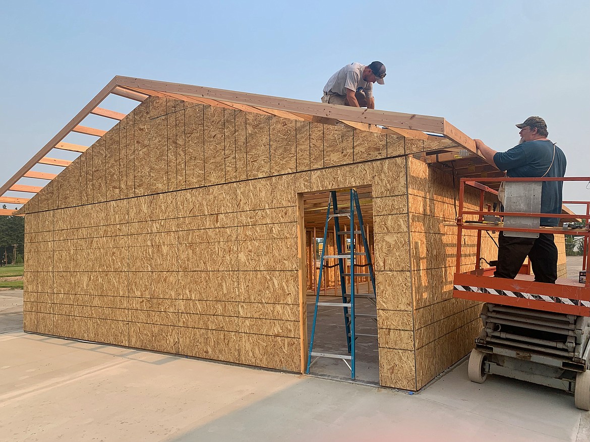 Tony Smith, a summer maintenance assistant for the West Valley School District, left, and Phil Jackson, the district's maintenance supervisor, construct two additional classrooms at the West Valley School on Tuesday, July 20, 2021. (Hilary Matheson/Daily Inter Lake)