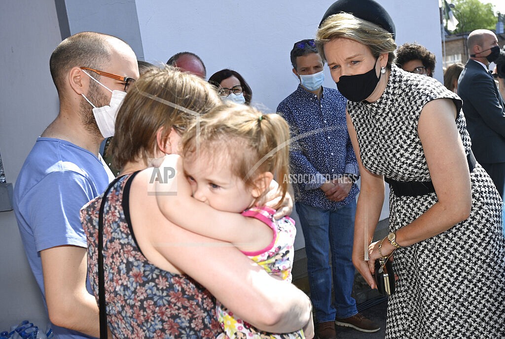 Belgium's Queen Mathilde, right, speaks with residents affected by the floods, prior to participating in a ceremony of one minute of silence to pay respect to victims of the recent floods in Belgium, in Verviers, Belgium, Tuesday, July 20, 2021. Belgium is holding a day of mourning on Tuesday to show respect to the victims of the devastating flooding last week, when massive rains turned streets in eastern Europe into deadly torrents of water, mud and flotsam. (Eric Lalmand, Pool Photo via AP)