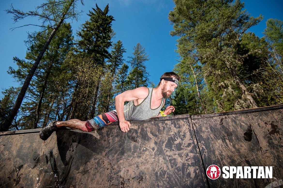 Ryan Nollan climbs over a wall obstacle during a Spartan Race.
Courtesy photo