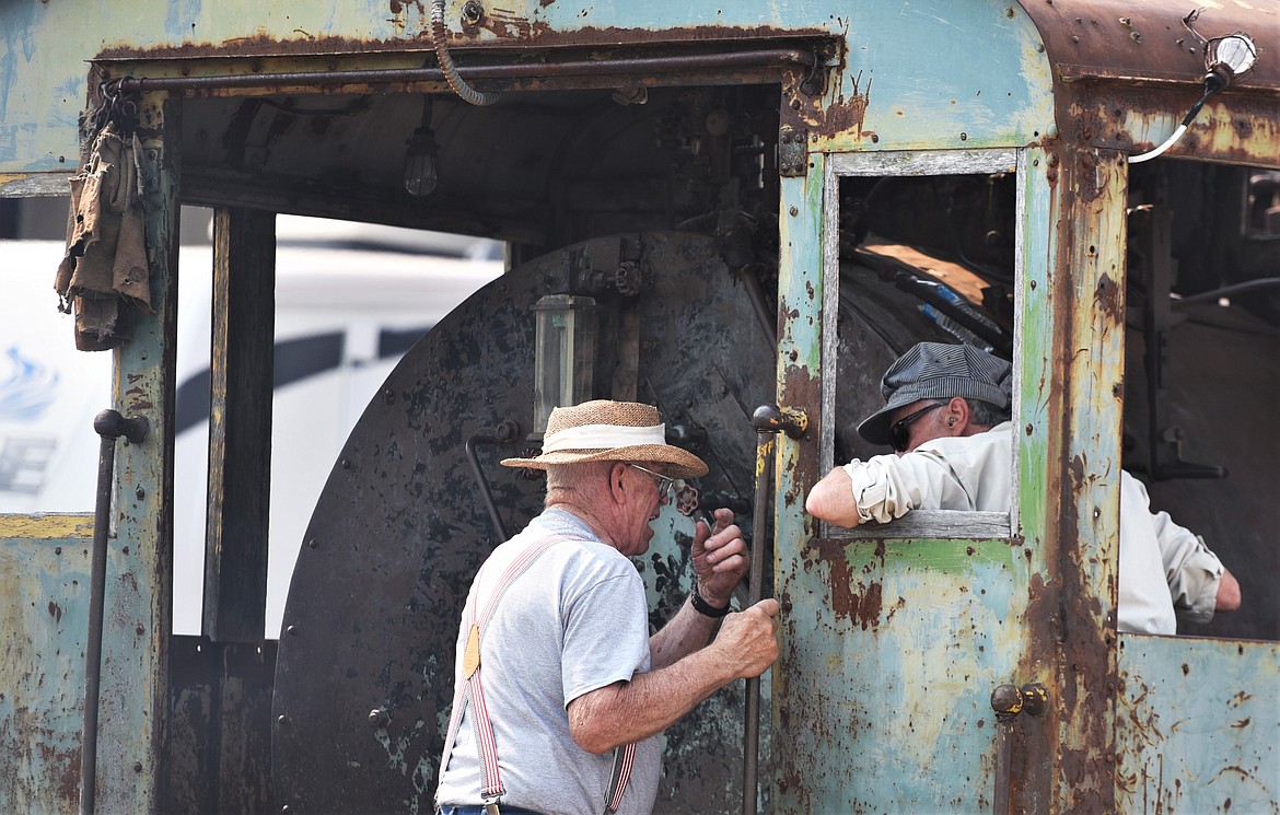 Museum founder Gil Mangels, left, talks with volunteer JD Cass of Havre on Saturday. (Scot Heisel/Lake County Leader)