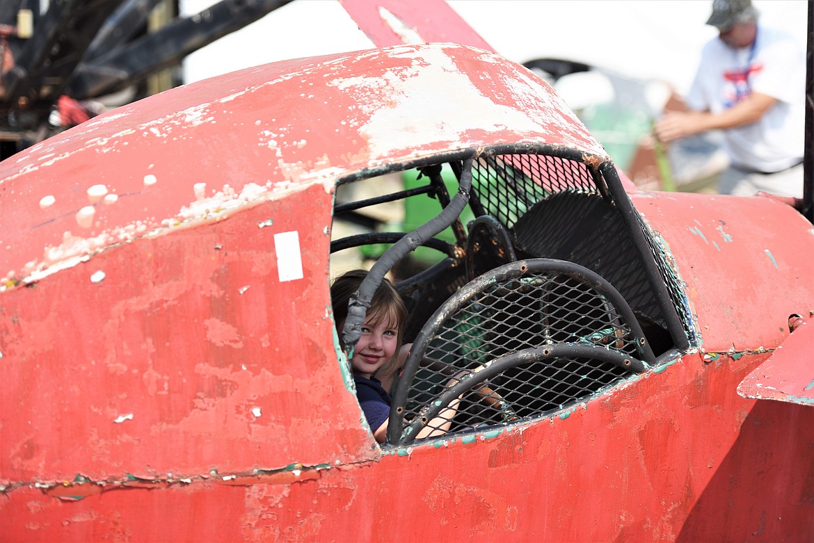 A young lady takes a spin on the Fly-a-Plane ride on the grounds of the Miracle of America Museum. (Scot Heisel/Lake County Leader)