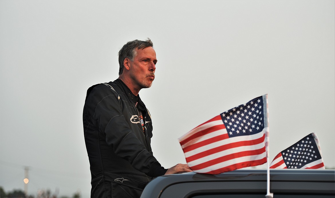 Dave Garber of Spokane is escorted to the front of the track prior to the race. (Scot Heisel/Lake County Leader)