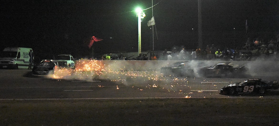 Sparks fly from the No. 21 car of BJ Tidrick as Cory Wolfe of Ronan smashes into the side of Alex Lessor's car on lap 101. (Scot Heisel/Lake County Leader)