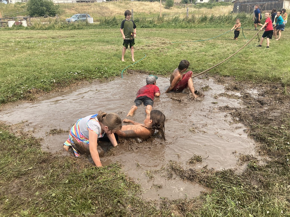 Tug-of-war participants find themselves buried in mud. (Carolyn Hidy/Lake County Leader)