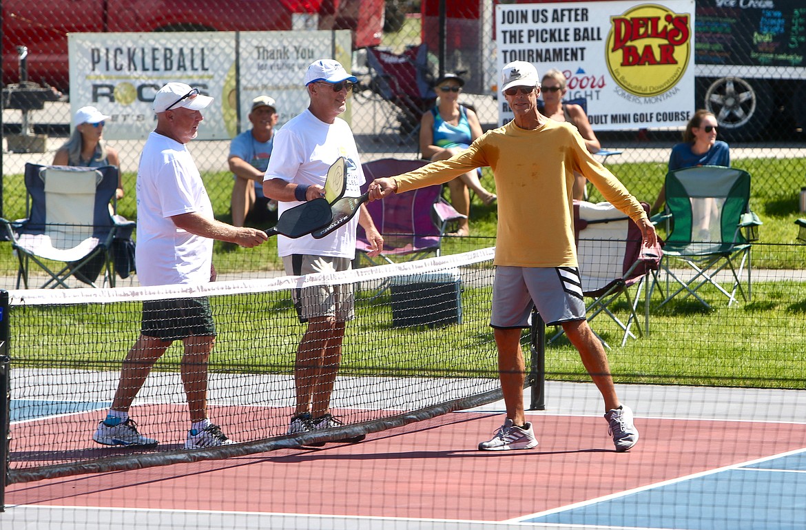 Pickleball players tap their paddles between matches during the 2021 Crown of the Continent Pickleball Tournament on Friday, July 16. 
Mackenzie Reiss/Bigfork Eagle
