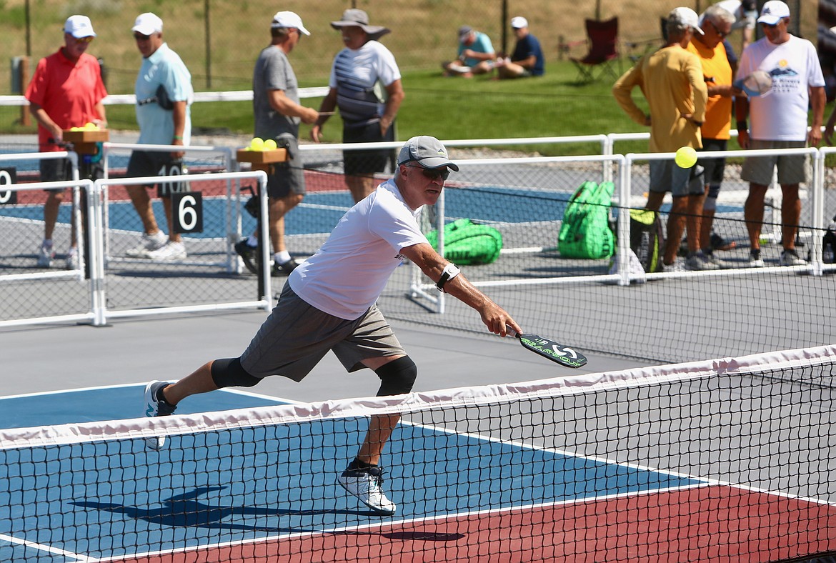 A pickleball player sends the ball soaring over the net during men's doubles action on Friday, July 16. 
Mackenzie Reiss/Bigfork Eagle