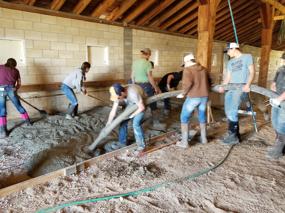 With local mentors on hand to help and answer questions, students in Casey Lunceford's ag operations class poured a new concrete slab in the hog area at the Lake County Fairgrounds in April. (Courtesy of Sjann Vincent)