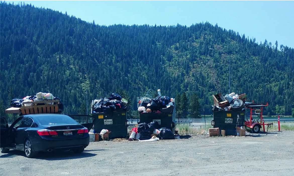 Images from a resident near Wolf Lodge Bay shows a mounting pile of trash in front of the North Idaho tree line. Photo courtesy the Kootenai County Solid Waste Department.