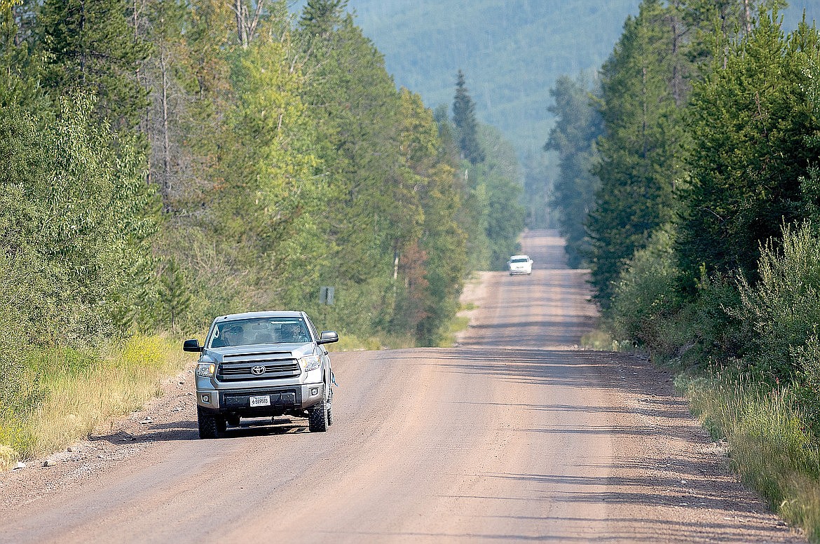 A car drives on a treated section of the North Fork Road. (Chris Peterson/Hungry Horse News)