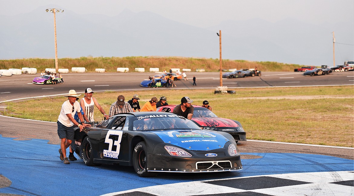 Alex Lessor's crew pushes his No. 53 car to the front of the track for the pre-race lineup. (Scot Heisel/Lake County Leader)