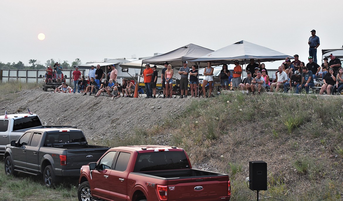 The crowd watches from the new bleachers west of the beer garden as the sun sets. (Scot Heisel/Lake County Leader)