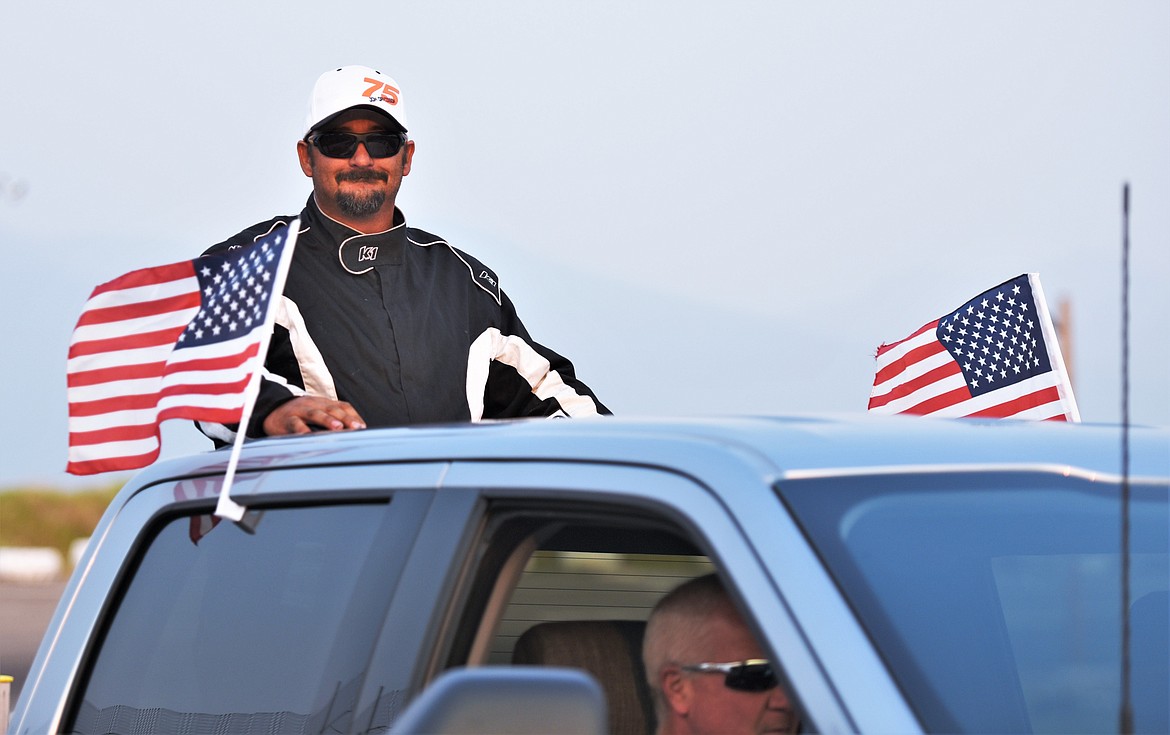 Jon Davisson of Kalispell is escorted to the track prior to the race. (Scot Heisel/Lake County Leader)