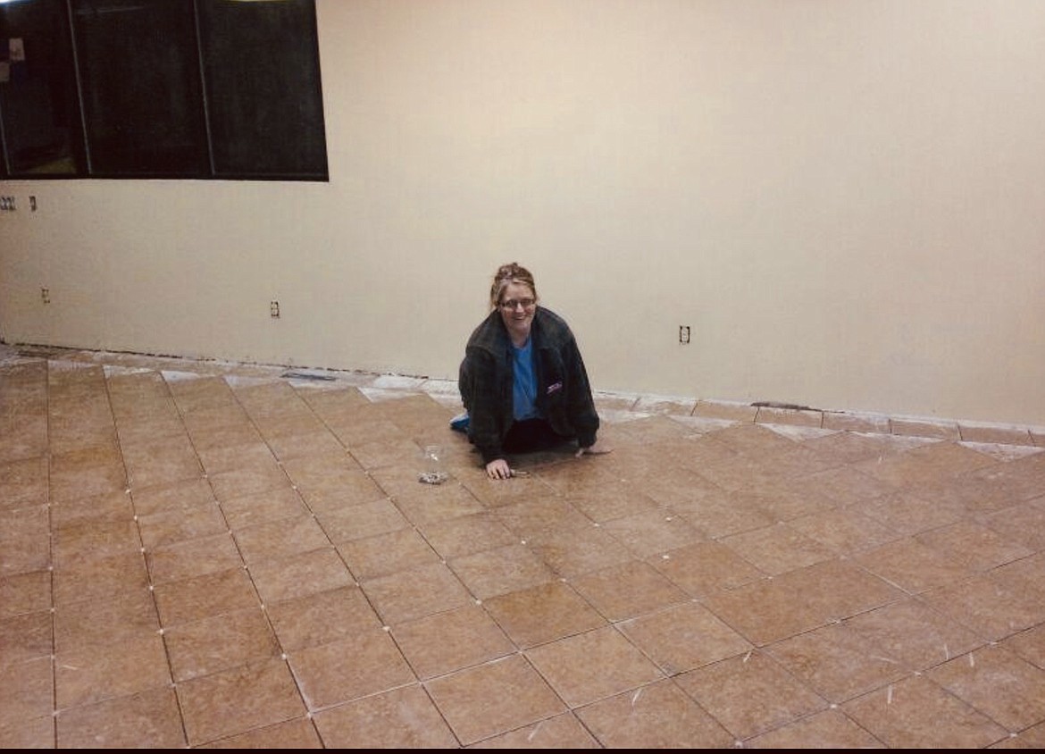 Gigi Kotschevar shows off her grouting skills during the remodel of Mullan Trail Gas and Grocery in 2014.