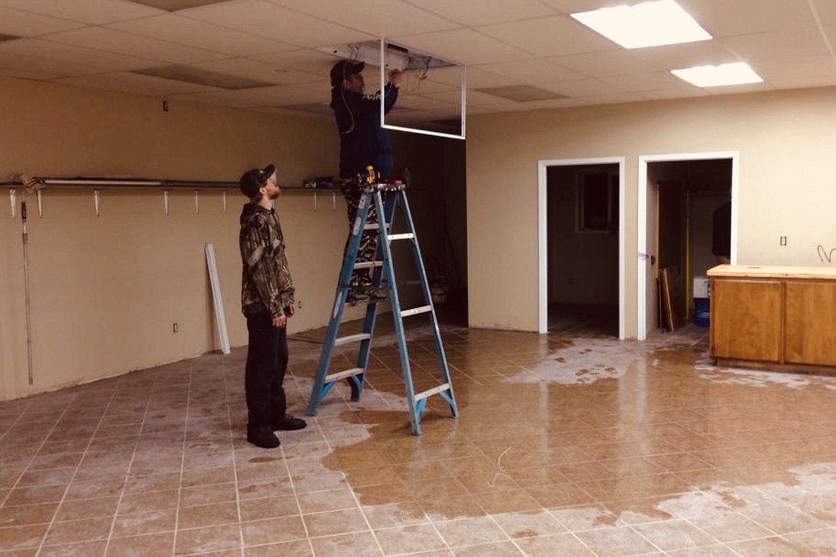 Working on the electrical system on a wet floor — what could possibly go wrong? New lighting was part of the full interior remodel of the building that formerly housed the Polla-Mart.