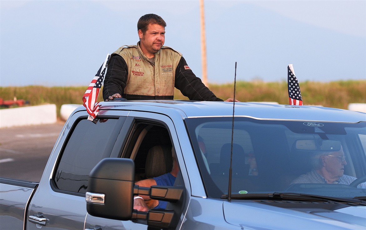 BJ Tidrick of Kennewick, Wash., is escorted to the track prior to the race. (Scot Heisel/Lake County Leader)