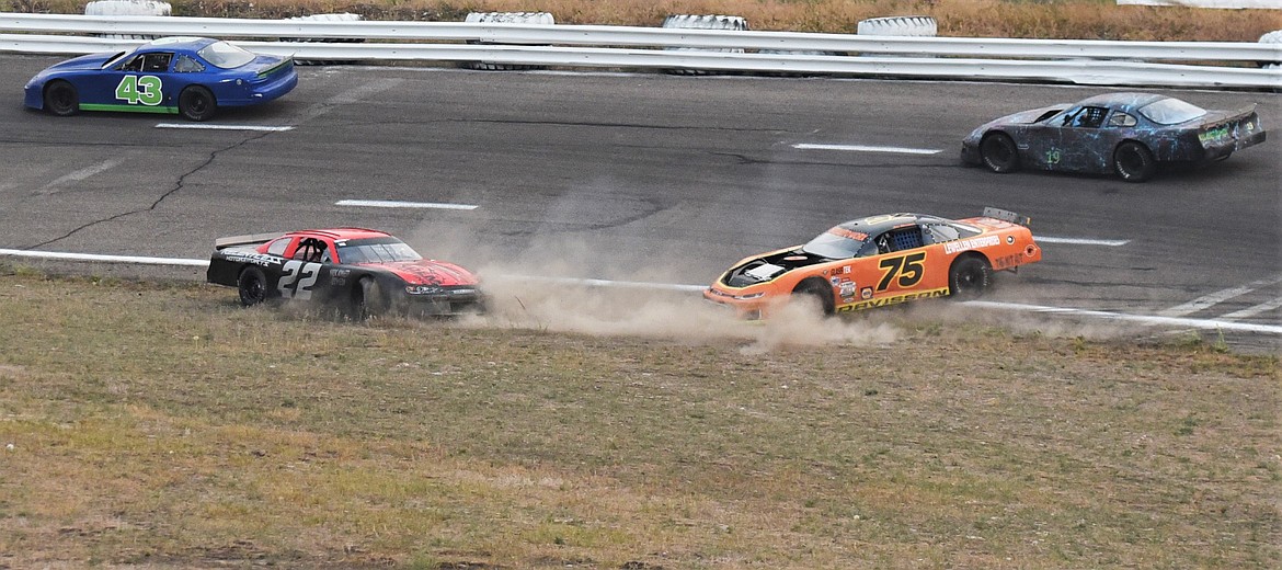 JD Undem (22) and Jon Davisson (75) head toward the infield during a turn 1 spinout. (Scot Heisel/Lake County Leader)