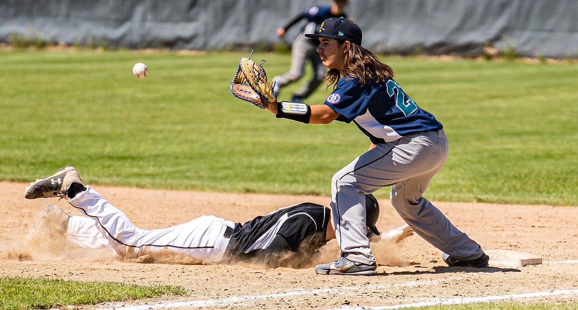 Johnny Montemayor makes a catch for the play at first base for the Columbia Basin Riverdogs 15U team earlier this summer.