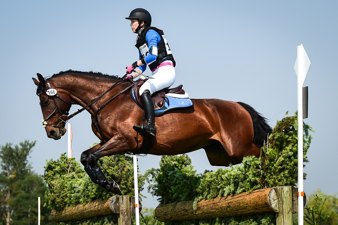 Rose Lemke and Watch Maker C clear a jump in the Training Three-Day cross-country course at The Event at Rebecca Farm on July 23, 2021. Money raised during The Event through parking donations, silent auction proceeds and donations from competitors and individuals goes to Halt Cancer at X, a charitable initiative of Montana Equestrian Events. (Casey Kreider/Daily Inter Lake file)