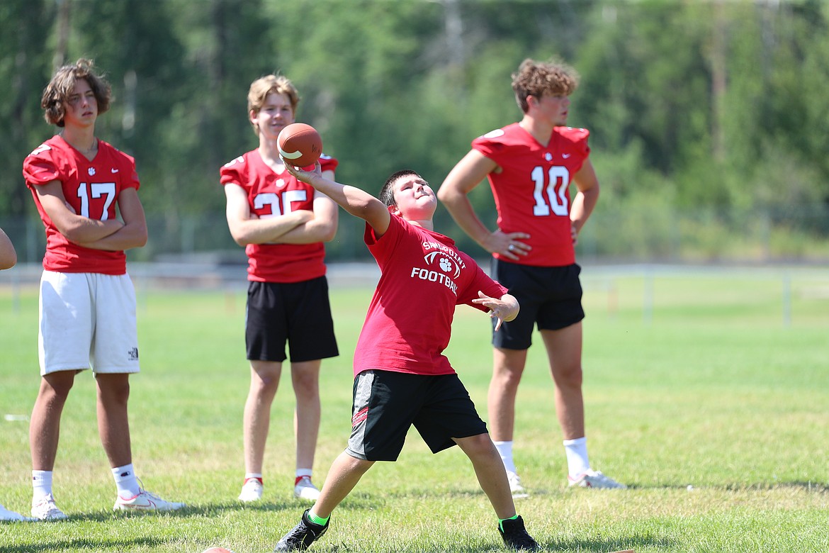 A camper tosses the ball during the longest throw competition on Friday.