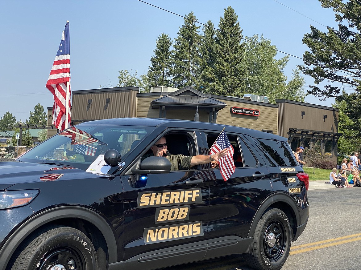 Kootenai County Sheriff Bob Norris stopped to wave at kids during the Hometown Heroes Hayden Days parade Saturday morning. (MADISON HARDY/Press)