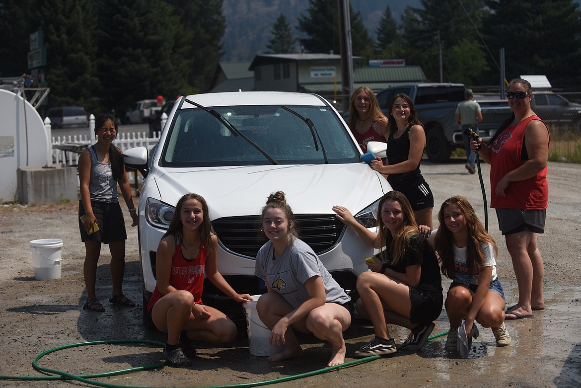 Members of the Noxon volleyball team held a car wash and baked good sale last Saturday in Trout Creek to help raise money for new uniforms. There was no shortage of takers for either as chocolate treats tempted patrons to the Trout Creek Local Store and plenty of dusty and muddy vehicles received some tender loving care. (Scott Shindledecker/Valley Press)