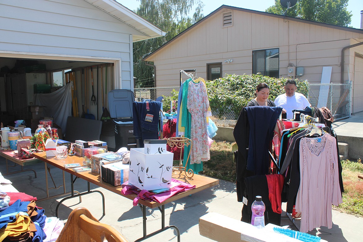 Customers peruse donated goods offered by Serve Moses Lake on Saturday.