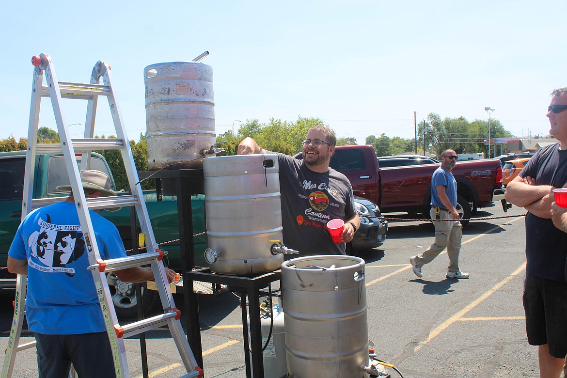 Adam Oman checks  his brew at Saturday’s Learn 2 Brew event at Squirrel Fight Artisan Brewing in Moses Lake.