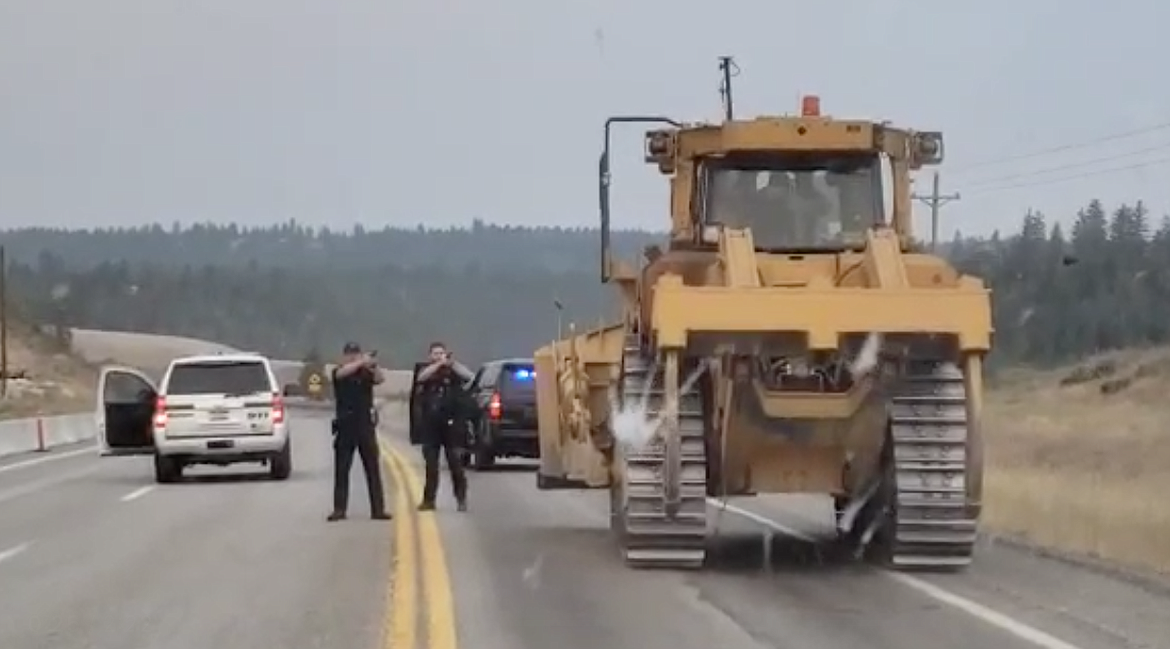 Law enforcement are pictured stopping Allen Funkhouser on Highway 95 after he was accused of driving a stolen D8-T Caterpillar on July 18.