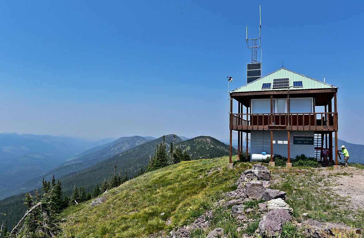 Volunteers work to repair the Werner Peak Lookout, which stands at an elevation of 6,960 feet in the Whitefish Range with uninterrupted views of the surrounding peaks and valleys. (Whitney England/Whitefish Pilot)
