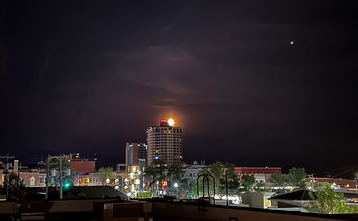 Downtown resident Judith Yancey caught the moon peeking over the Parkside Tower's shoulder around 11 p.m. Monday.