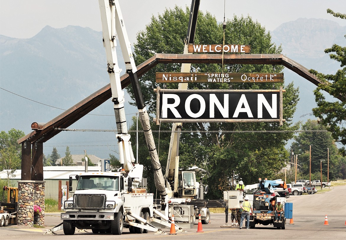 Crews installed new entry signs on the arch on Main Street in Ronan on Monday. The plan to replace the arch and sign began a few years ago as a Ronan High School class project. The previous sign and arch were removed and the new arch was installed in 2019. The top signs reads “Welcome,” followed by “Spring Waters” in English, Salish and Kootenai. The Ronan Arch Committee has been seeing the project through to its completion. The committee is planning a celebration in the fall once school resumes. (Scot Heisel/Lake County Leader)