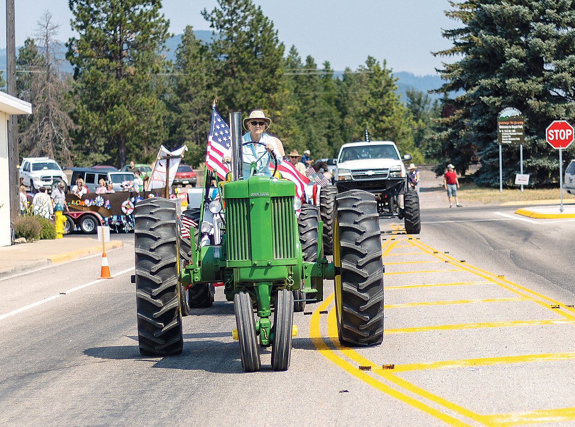 A vintage John Deere tractor rolls through the parade.