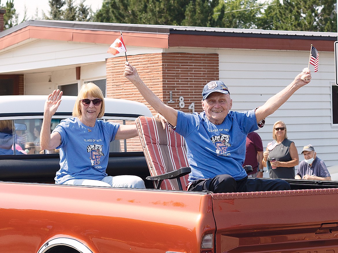 Longtime teacher Doug Follett, right, rides with the class of 1970.