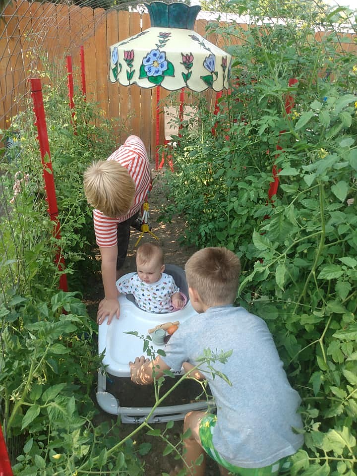 Hawks' sons Hendrick and Camden play in the garden with their younger sister, Waverly.