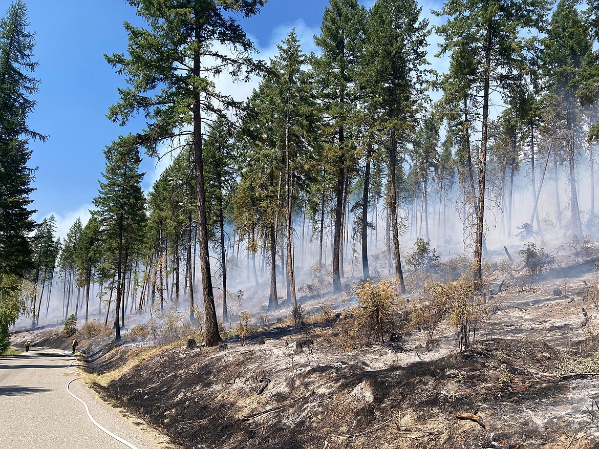 Firefighters on the South Yaak Fire work along Kilbrennan Lake Road in this July 25, 2021, file photo. (InciWeb)