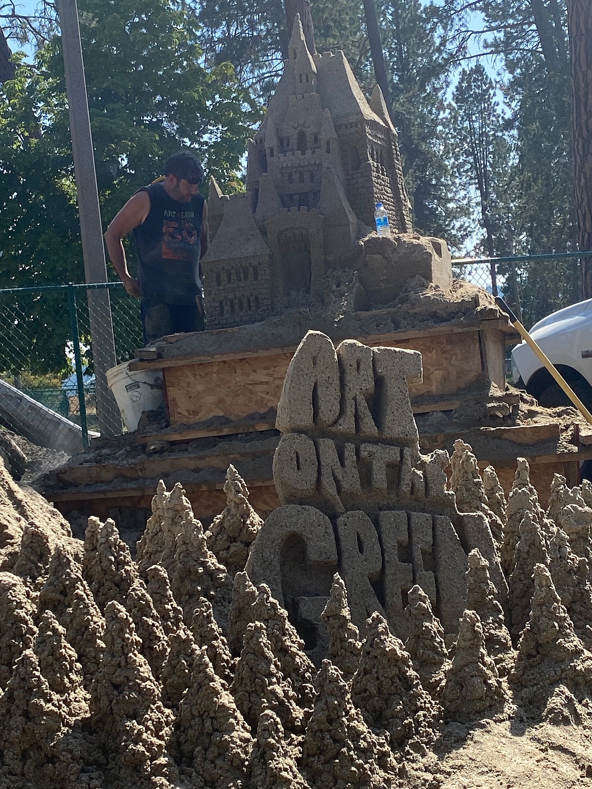 Amidst a flurry of activity Thursday afternoon, Coeur d'Alene resident Scott Dodson and his son Jonathan build the Art on the Green sandcastle. "This is our 23rd year," Dodson said.