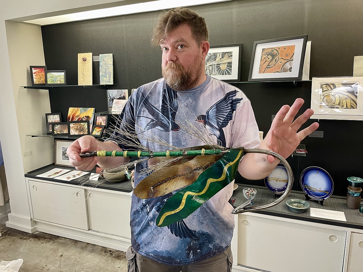 Basalt Collective art gallery owner Nate Ulmer with a giant fly fishing hook sculpted by regional artist Andrea Johnson.