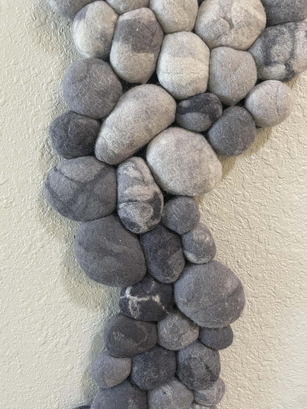 A portion of Ron Ulrich’s creation “River Rock,” a collection of solid felt balls made to look like rocks on the bed of a mountain stream.