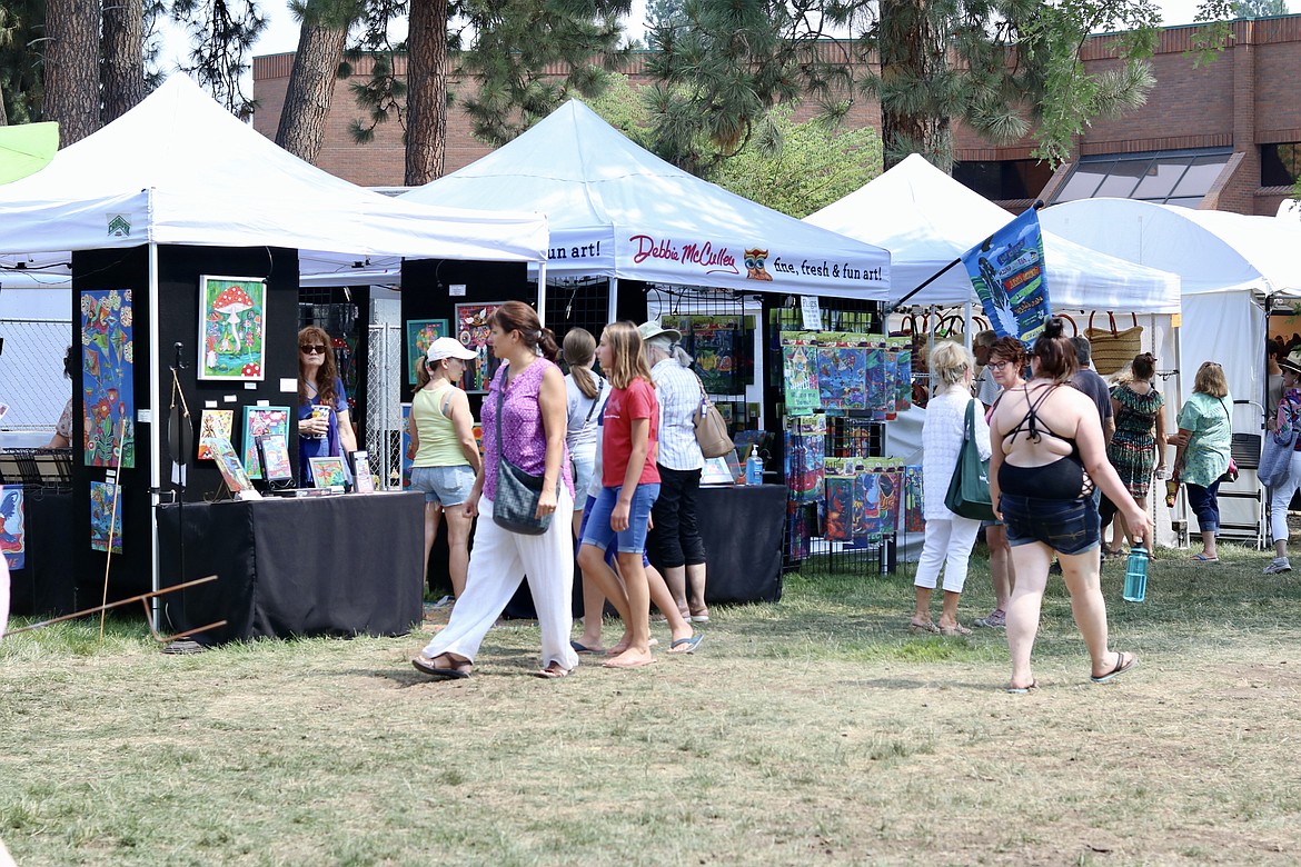 People flocked to North Idaho College campus on Friday to view art created by artists all over the U.S. in the Art on the Green event which runs through Sunday. HANNAH NEFF/Press