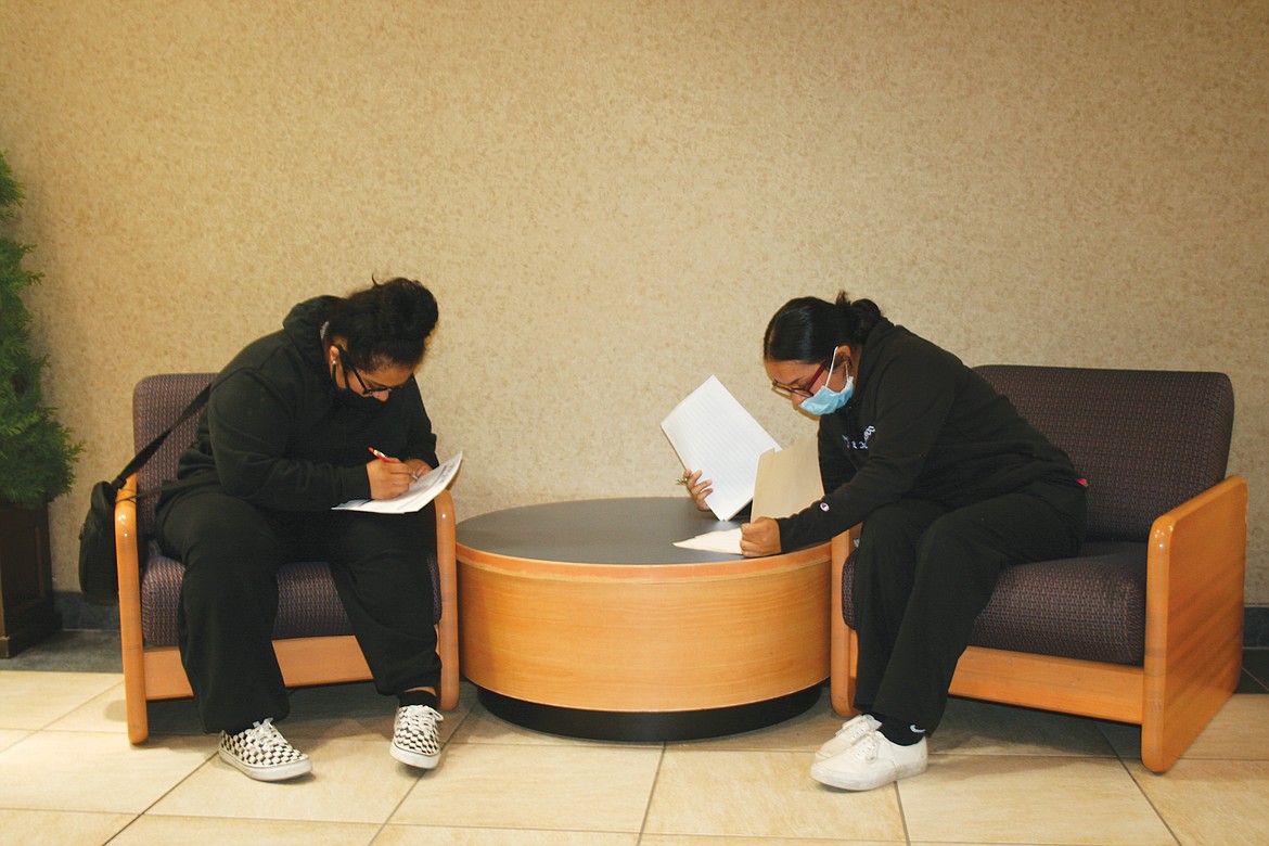 Andrea Gonzales (left) and her sister Vanessa Gonzales fill out applications during the summer job fair Thursday at Big Bend Community College.