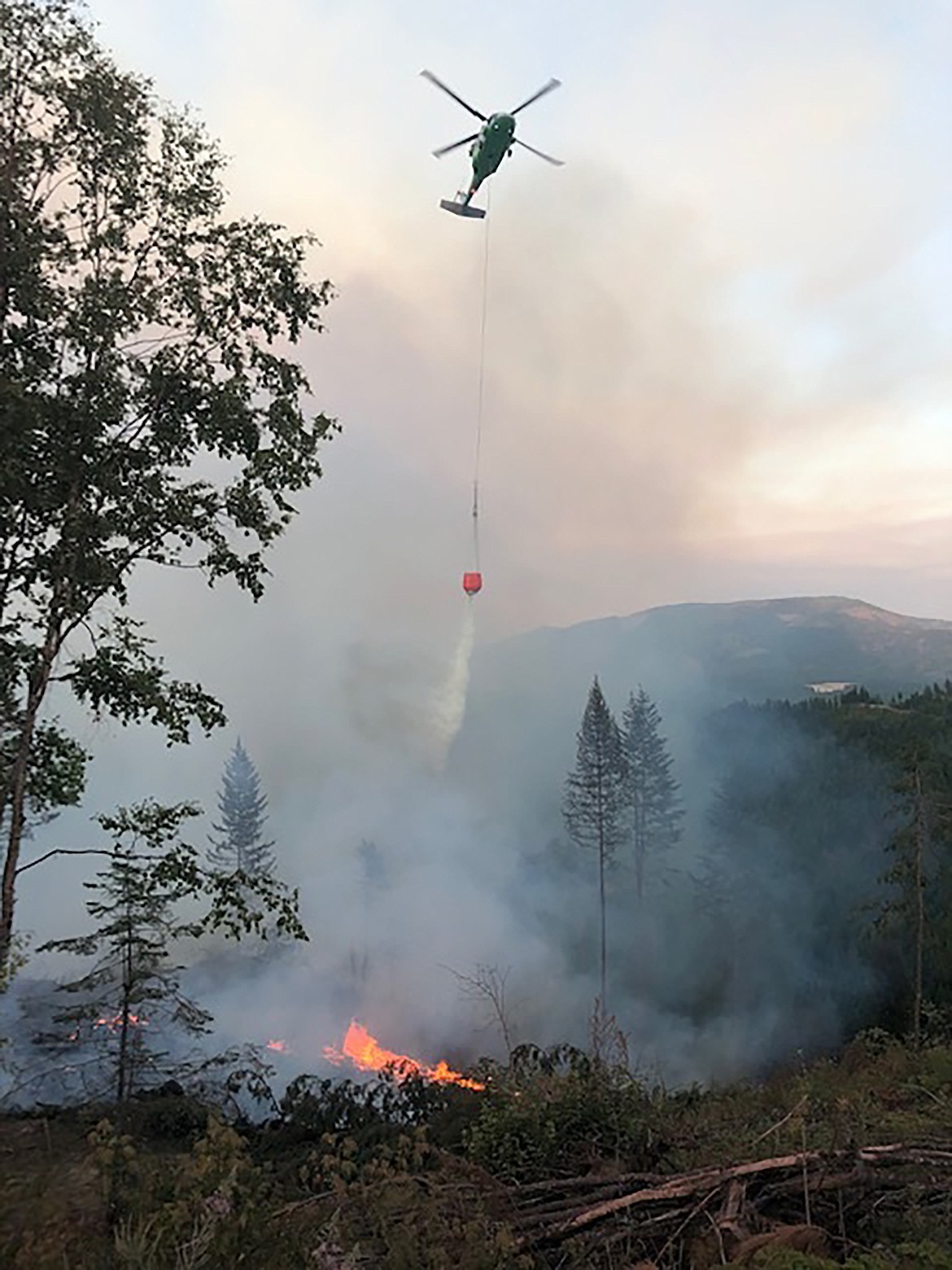 A helicopter drops water on the Pioneer Fire on Thursday during an air attack on the fire.