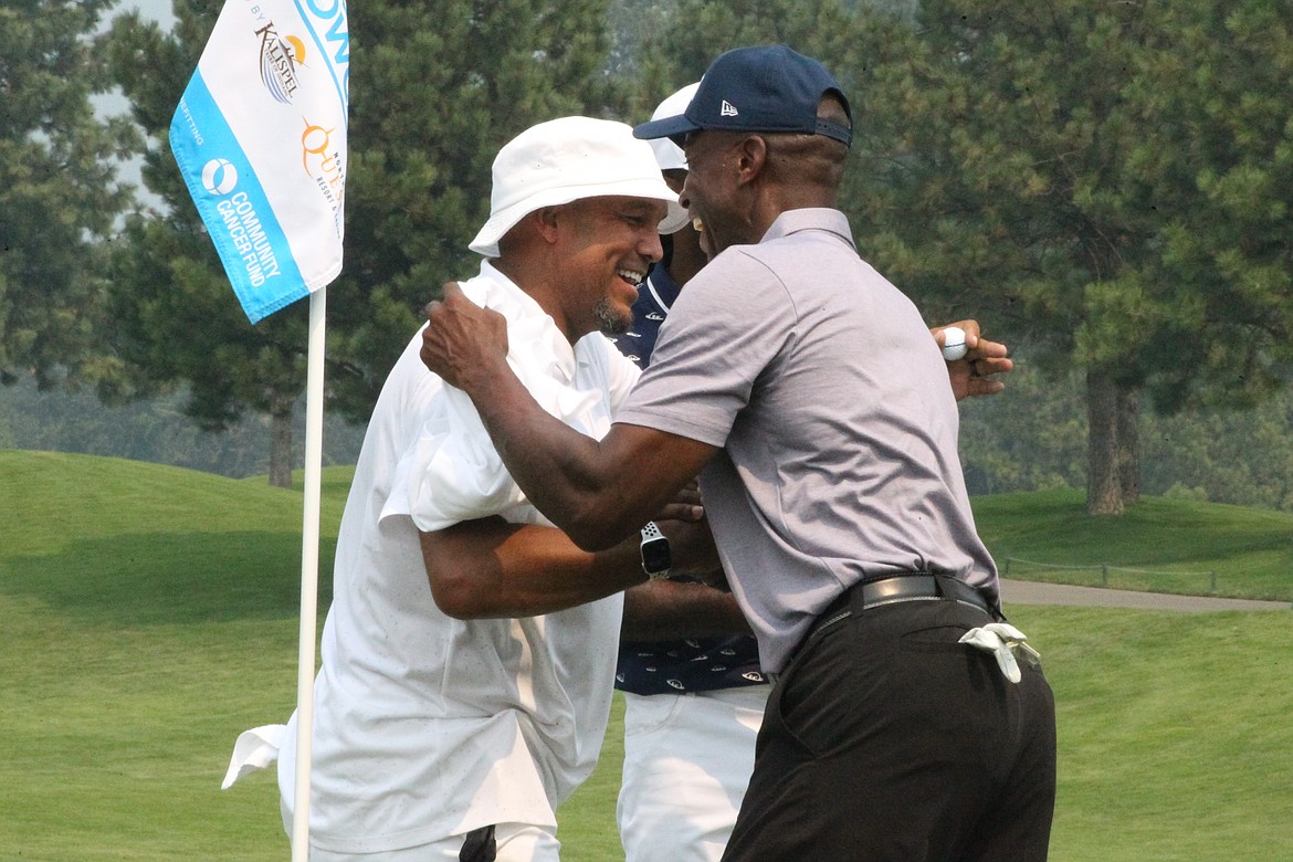 JASON ELLIOTT/Press
Former Major League Baseball outfielder David Justice, left, hugs fellow MLB star Fred McGriff following the completion of the final round of The Showcase golf exhibition on Saturday at The Coeur d'Alene Resort Golf Course.
