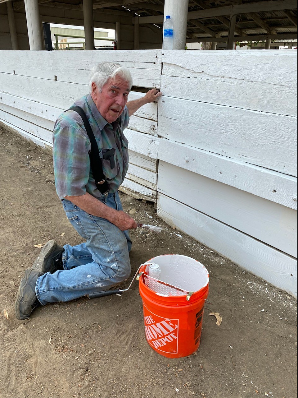 88-year-old volunteer Joe Sporcic paints a barn at the Grant County Fairgrounds on Saturday.