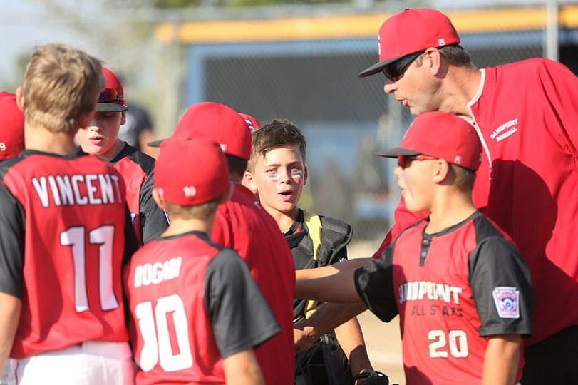 Coach Brent Eacret rallies the team between innings during the championship game against Brewster.